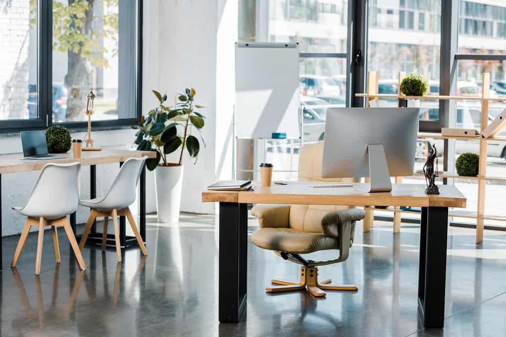 Interior of business office with wooden furniture and computer on table